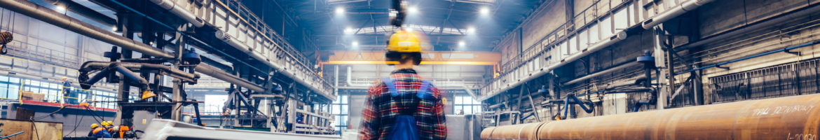 steel manufacturing plant with engineers wearing hardhats