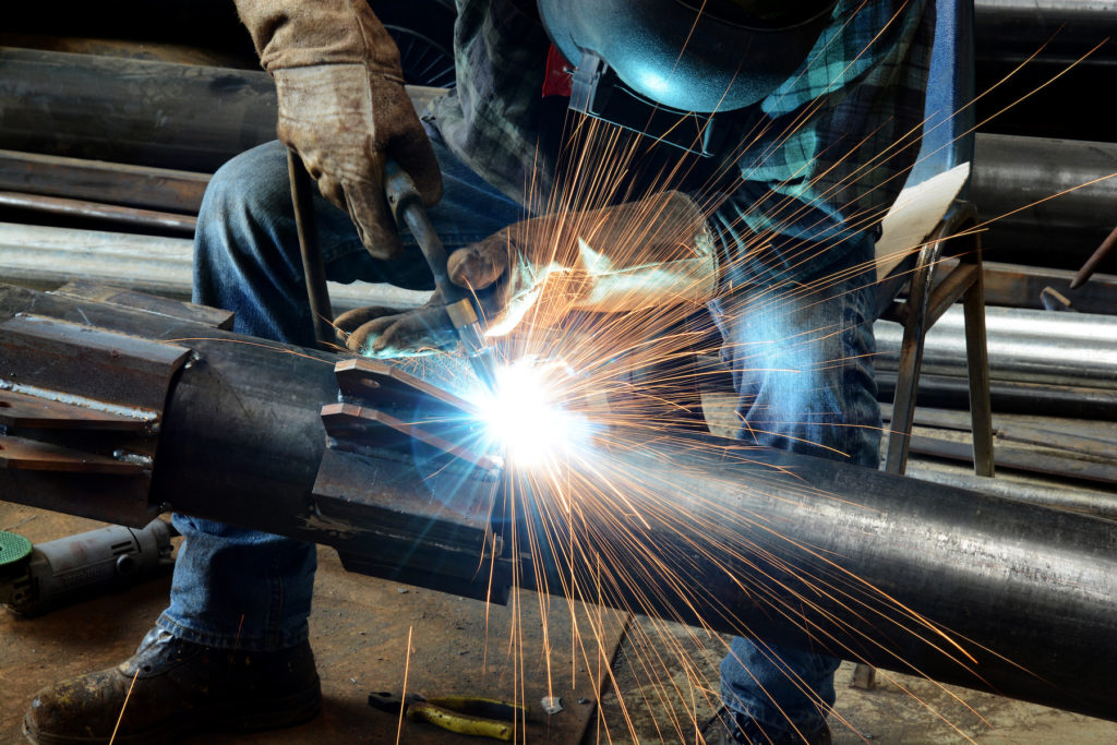 a welder working on steel fabrication