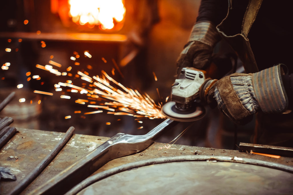 worker sawing the iron