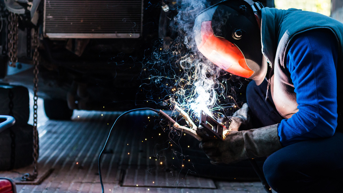 A person performing custom metal fabrication in El Paso.